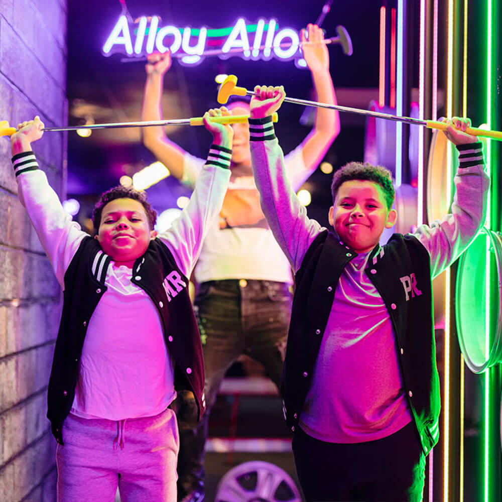 Family enjoying a round of crazy golf at Putt Club during the summer holidays